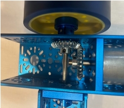A blue and yellow metal object with a wheel

Description automatically generated