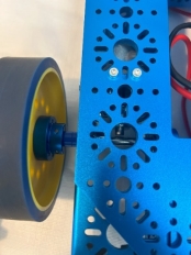 A blue metal object with a wheel

Description automatically generated