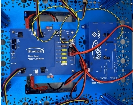 A blue electronic device with wires

Description automatically generated