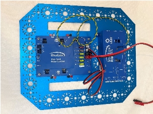 A blue electronic device with wires

Description automatically generated